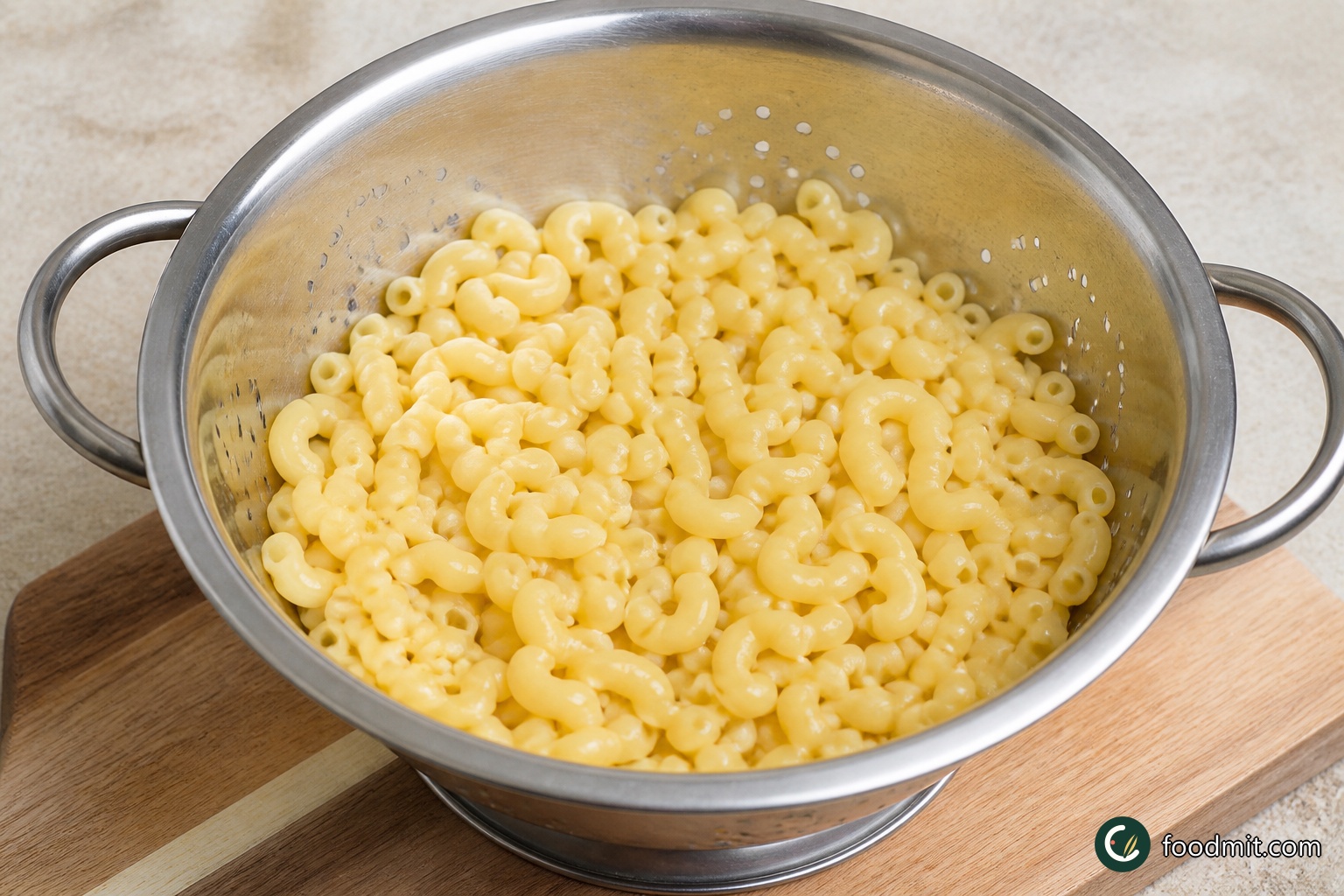 Bring a large pot of well-salted water to a boil. Add the elbow macaroni and cook it according to its package directions only until al dente. The curves should be tender enough to bite but still have a slight firmness at the center, since they will continue cooking in the oven. Drain the macaroni thoroughly and have it ready before finishing the cheese sauce.
