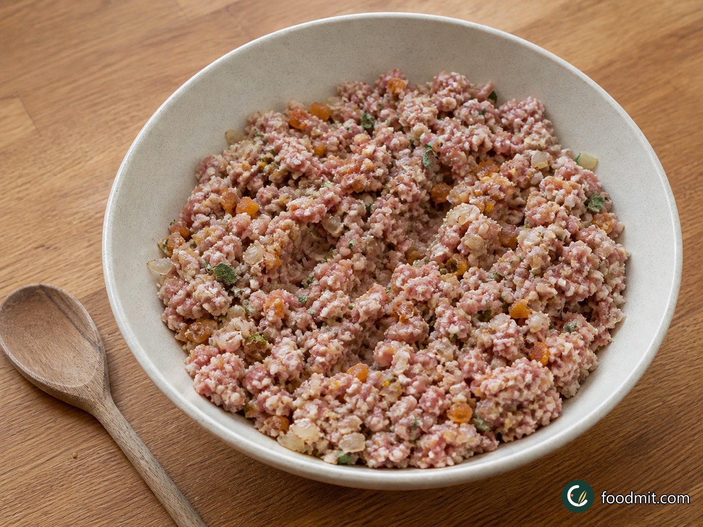 Remove the sausage meat from its casings and put it in a large bowl. Pick and roughly chop the sage leaves, roughly chop the dried apricots, and add both with the fresh breadcrumbs and cooled onion mixture. Mix with clean hands until the fruit, herbs, and crumbs are evenly distributed, without packing the mixture down.