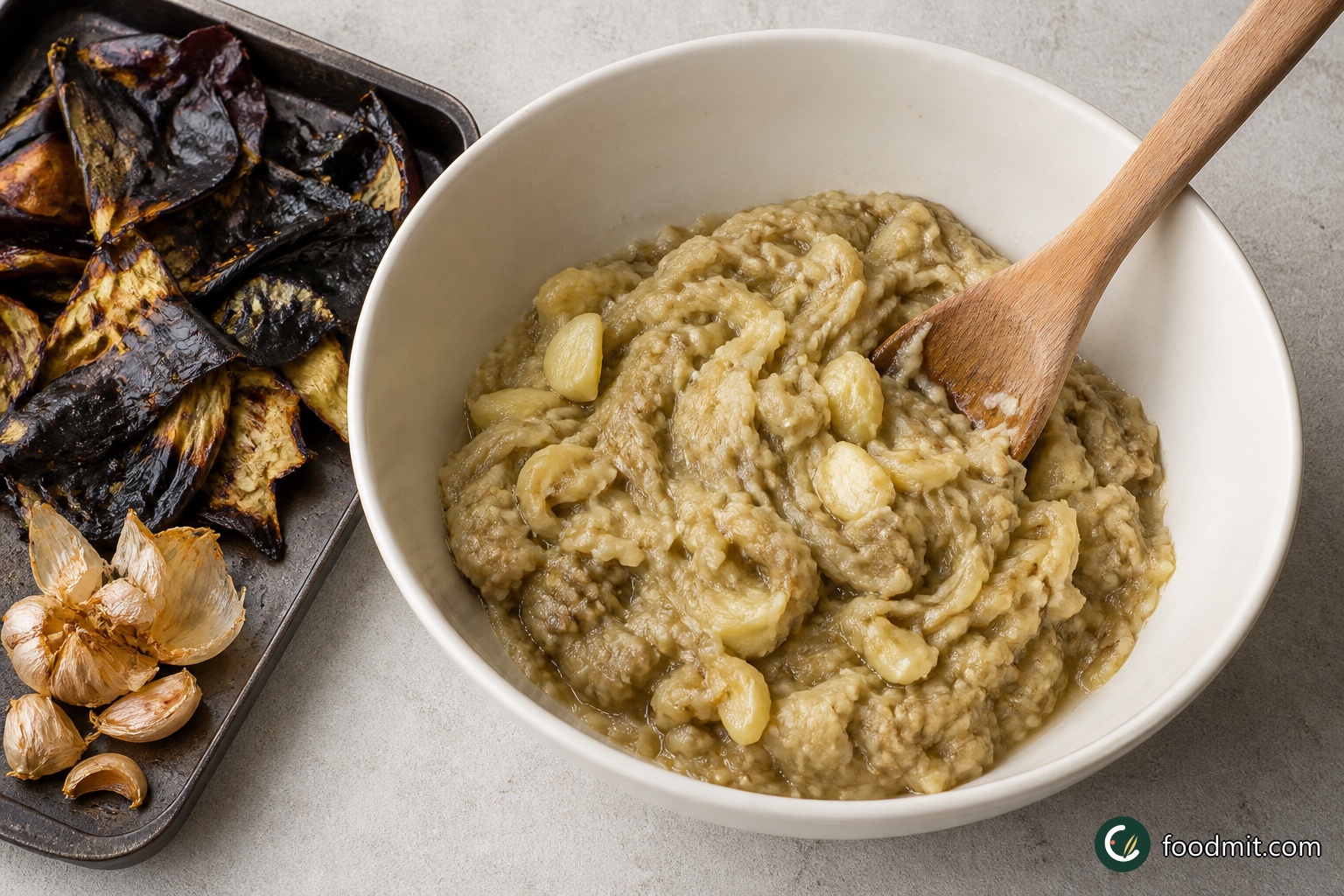 Split the roasted aubergines lengthways. Scoop their very soft flesh into a large bowl and discard the charred skins. Separate the roasted garlic cloves and press their mellow flesh from the papery skins into the same bowl. Break up and crush the aubergine and garlic together, keeping a little texture rather than blending them smooth.
