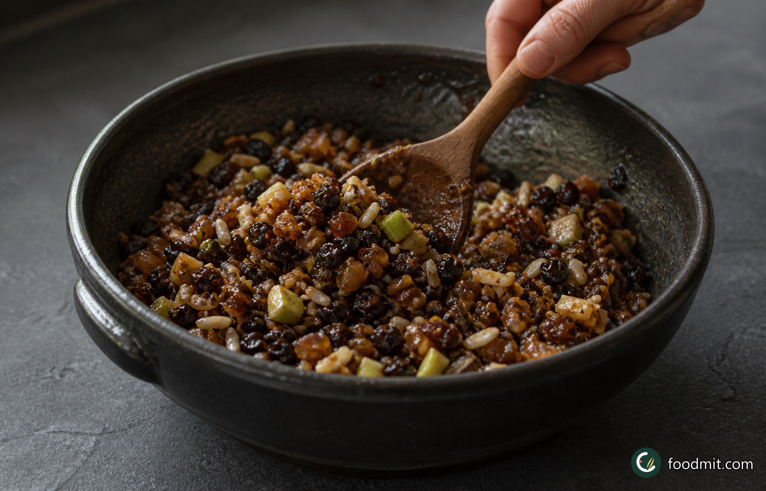 Leave the mincemeat in its bowl and stir it gently from time to time as it cools, bringing the wetter mixture at the bottom up through the fruit. With each stir, the melted suet will become less separate and will begin to coat the apple and dried fruit. Continue until the mixture is completely cold, cohesive and spoonable, with no broad layer of liquid fat remaining on the surface.