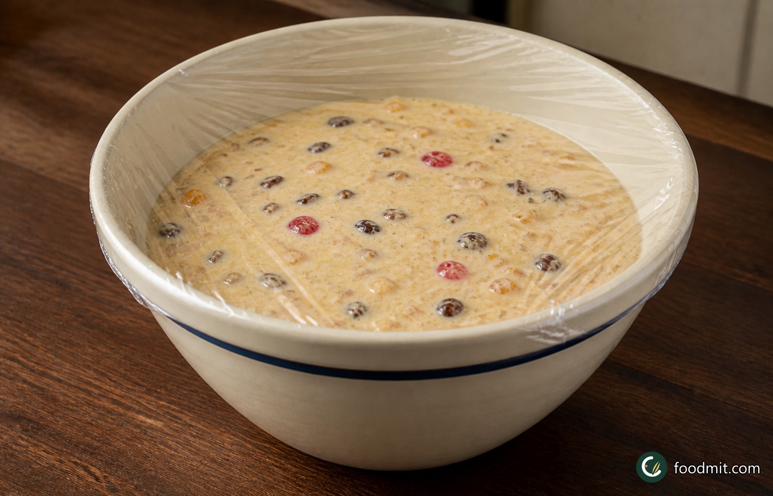 Stir the marinated fruit and all of its remaining rum into the cold base, mixing until the pieces are spread throughout. Pour everything into a 1.5 litre (2½ pint) pudding basin, cover closely with clingfilm and freeze until almost set. This can take up to 7 hours; it is ready for the next stage when it has the consistency of soft-scoop ice cream rather than a solid block.